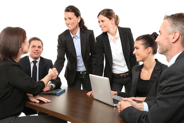 A professional team of property managers meeting at a table, closing a deal